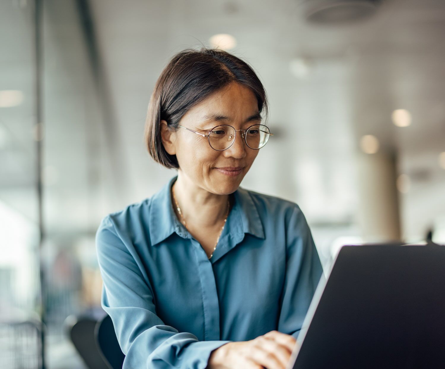 A woman works on a laptop