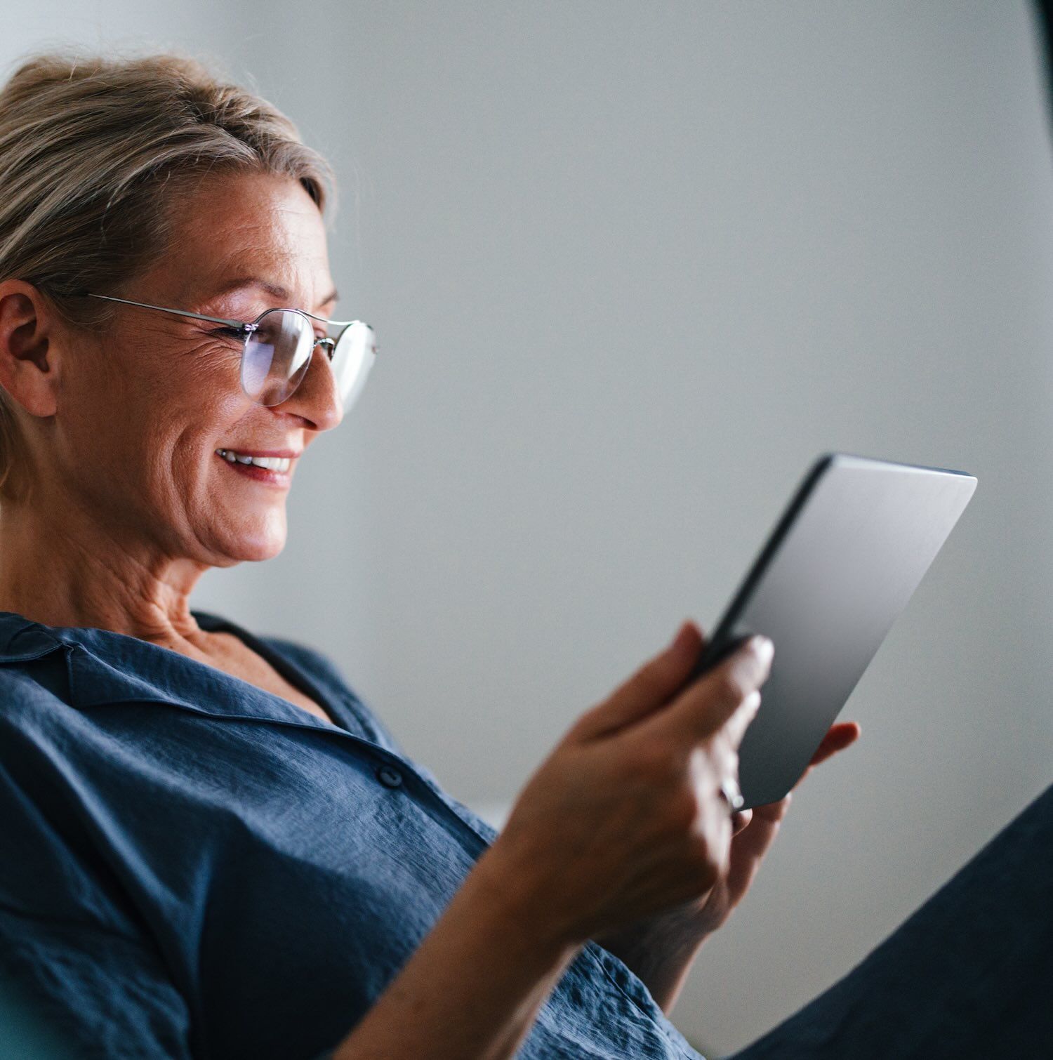 A woman reads on an electronic device