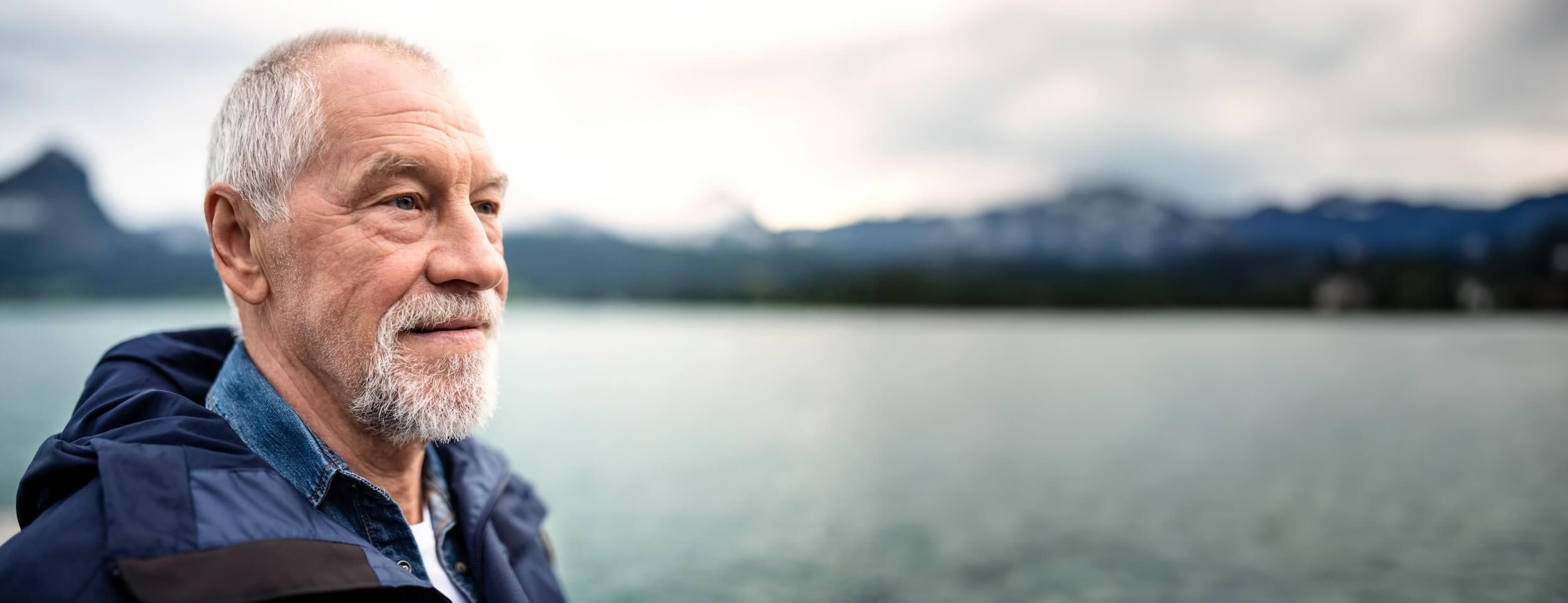 A man looks out over a lake